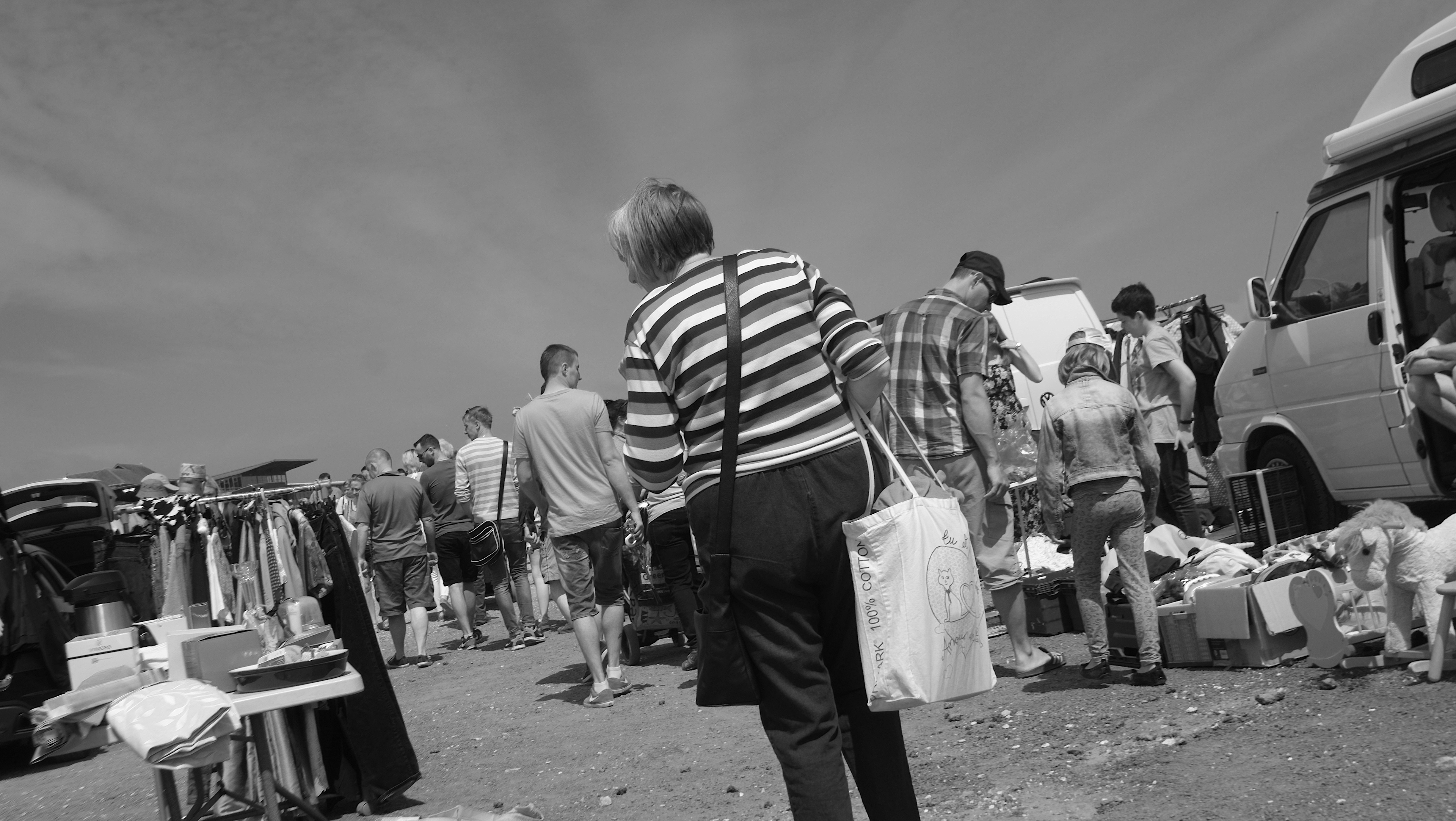 People looking at the things for sale.