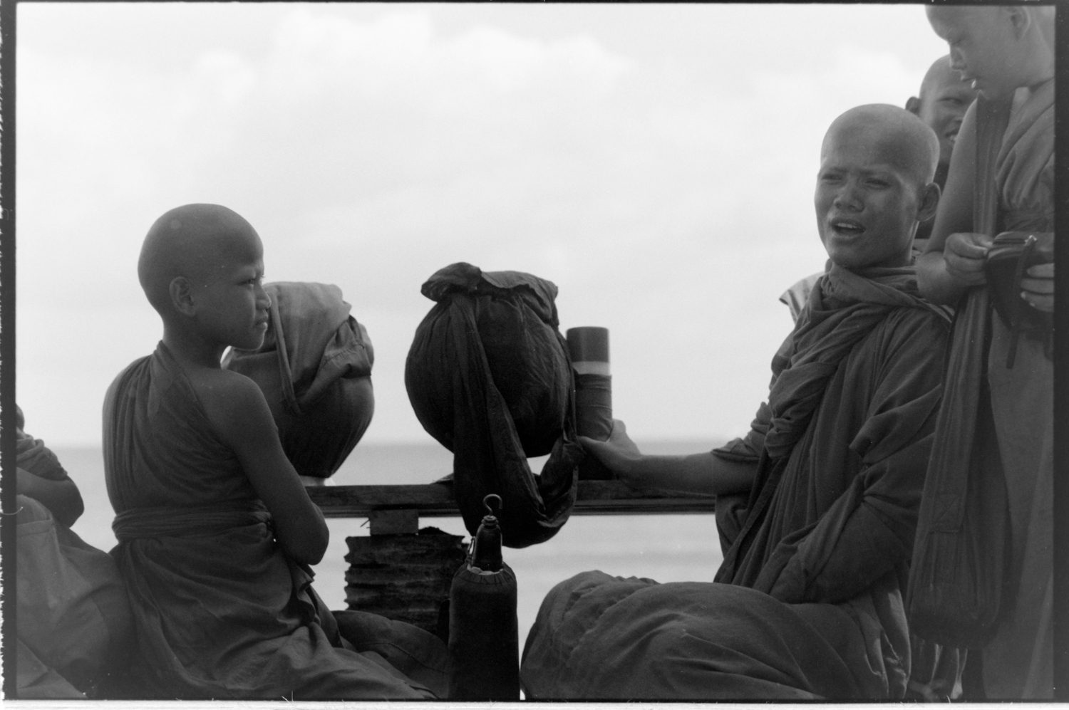 Students monks stopping at the beach with their teacher.