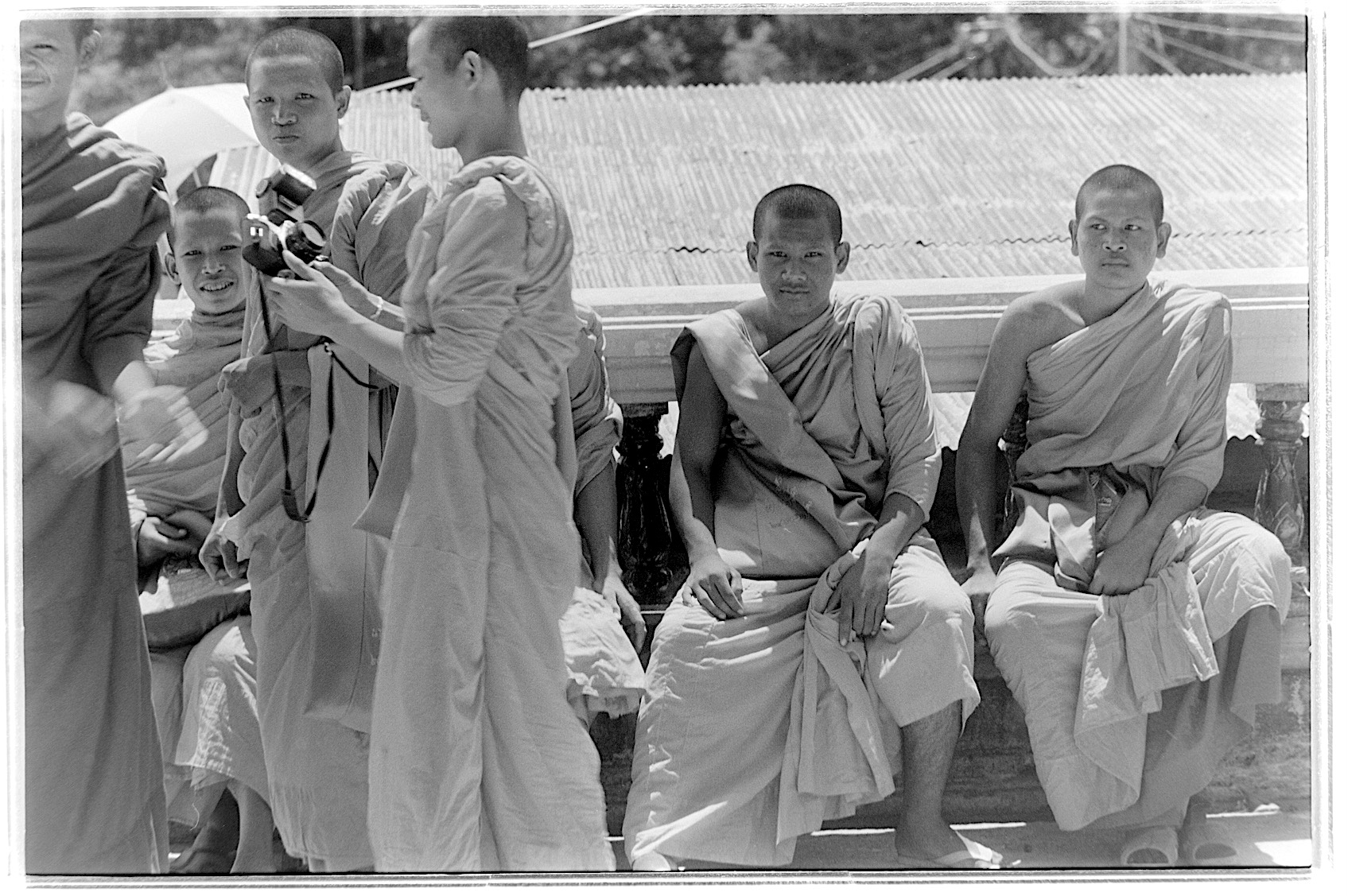 Thai monks waiting outside a temple near Bangkok, Thailand.